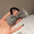 Close-up of a large bow hair tie with silver rhinestones and black elastic band - Style D Scrunchie / White
