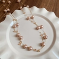 Long champagne pearl and crystal necklace with gold plating shown on ceramic plate - Long Multi-Bead Style / Champagne (12mm Pearl)