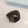 Folded kids' dark grey transparent sunglasses with UV protection on a textured surface - Smoke Gray