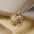 Elegant gold heart pendant necklace with colorful zircons on a beige knitted sweater - Gold Colorful Heart