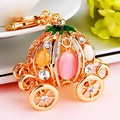 Golden pumpkin carriage keychain with colorful rhinestones on a pink background - Cinderella Pumpkin Carriage Pink