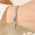 Macro view of silver stainless steel bangle with a row of inlaid square zircons - Silver (29-D-12)