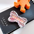 Pink checkered bone-shaped knit hair clip with Cute lettering on a notebook - Bone-Plaid Pink