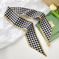 Narrow silk scarf featuring classic black and white houndstooth pattern with tan border - Houndstooth