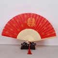 Traditional red bamboo folding fan featuring Double Happiness patterns and a silk tassel - White Ribs Style 47