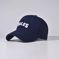 Close-up of white 3D TALES embroidery on navy cotton canvas baseball cap crown - Navy Blue