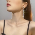Elegant silver tassel earrings with sparkling rhinestones in a wavy luxury drop design - Silver Wave Curved Tassel Earrings