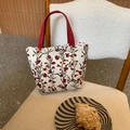 Detail showing vintage corduroy floral handbag texture on a cozy chair with snacks - Beige Wind Flower