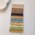 Close-up of multicolor braided hair ties set on card, featuring high elastic fibers - Bamboo Texture Cool Tone Set / 32 Pieces