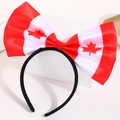 Detail of Canadian flag themed bow headband with iconic red maple leaf pattern - Canada Flag