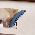 Detailed macro view of matte blue banana hair clip with secure teeth and sphere detail - Haze Blue