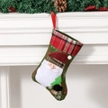 Green Christmas stocking with Santa Claus embroidery and red plaid cuff hanging on mantel - Small Santa Claus