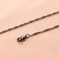 Detailed view of a black 18K stainless steel wave chain with a sturdy lobster clasp - 2mm 45+5cm Necklace / Black