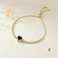 Close-up of adjustable copper heart bracelet with blue gemstone and micro-pave crystals - Blue