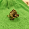Vintage brass zodiac rat holding peach keychain pendant with antique metal textures - Marmot