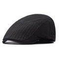 Detail view of adjustable metal buckle and leather strap on a black vintage flat cap - Gray