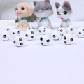 Close-up of white wooden beads featuring black paw print patterns for DIY crafts - White Base Black 3-Paw