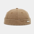 Detail of khaki cotton docker hat with vintage distressed holes and silver metal logo tag - Metal Label / Khaki