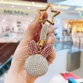 Close-up of rabbit head keychain featuring white and red rhinestones with gold star clip - Red