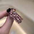 Détail de strass en cristal rose sur une pince à cheveux noire pour femme effet brillant - Rose