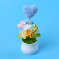 Detailed view of a handmade crochet heart plant with colorful flowers in a white ceramic pot - Blue Heart