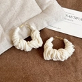 Detailed view of beige knit hoop earrings with golden clasp on soft textured fabric - Beige (S925 Sterling Silver Pin)