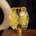 Elegant gold round shell tassel earrings hanging on a metal display stand for beach vacations - S4763-3 Style / Yellow