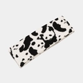 Close-up of knit headband featuring black and white panda patterns for winter warmth - Panda Style