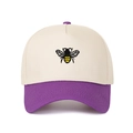 Detailed close-up of bee embroidery on a two-tone cotton twill trucker hat crown - Purple