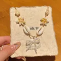 Detalle del collar de concha y estrella de mar de cerámica con un lazo de perla - 2# Collar-Blanco-Marrón