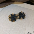 Macro detail of gold metal earrings with black cross-wrapped design and spring text - 62# Silver Earring Post - Gold - Black - Round