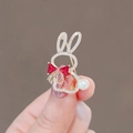 Elegant gold rabbit brooch with crystals, a red bow, and pearl tail on a gold finish - 83# Pink Rabbit