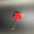 Close-up of a red satin rose lapel pin with a gold hollowed leaf on a long needle - Red