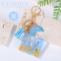 Ocean style resin letter M keychain with sand, seashells, blue tassel and fish tail - Letter M