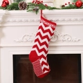 Red and white knitted Christmas stocking with snowflake patterns hanging on a fireplace - Style D Red White Wave Snowflake