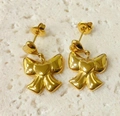 Macro shot of 14K gold plated bow earrings with heart center detail on stone texture - Bowknot Heart Studs / Gold