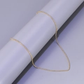 Detail shot of a sleek golden bead chain necklace hanging on a minimal grey pedestal - L61-Bead Chain / Gold