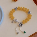 Vintage yellow bead bracelet with silver lucky charms and small bell pendant - Flat Round Imitation Amber: Fortune Flower Long Tassel Bracelet