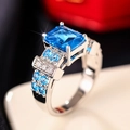 Macro detail of luxury square blue gemstone ring with four-prong silver metal setting - US 6 / Light Blue