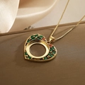 Golden heart pendant necklace with green and red zircons on a luxury leather display - Multi-Color Zirconia Heart (23305)