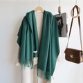 Solid dark green cashmere blend scarf with tassels shown in a stylish autumn outfit - Dark Green / 200cm