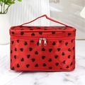Red makeup bag with black hearts, featuring a top handle and secure double zip closure - Red Heart