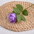 Artificial purple rose flower with realistic silk petals on a woven straw mat decoration - Purple