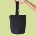 Minimalist black canvas bucket tote bag featuring natural wood rings and wide handles - Blank Black