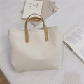Detailed shot of beige cotton tote bag with vertical stripes and leather rivet handles - Off White