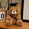 Brown plush graduation teddy bear with black cap, golden sash and diploma scroll - Black Sash Style / Dark Brown