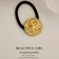 Minimalist elastic hair tie featuring a golden lava style textured metal button detail - Round Lava Rock Gold