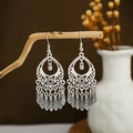 Detailed view of silver bohemian tassel earrings hanging on a natural wooden branch - E2874-35/Long Teardrop Pendant
