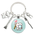 Creative dental themed keychain with toothbrush toothpaste and tooth charms on white background - Health Tooth Cartoon Icon