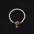 Elegant pearl bracelet featuring a gold T-bar clasp and a sparkling crystal letter V charm - Gold Letter V (SL2013)
